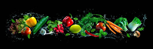 istock Fresh vegetables and water splashes on panoramic background 1285272095