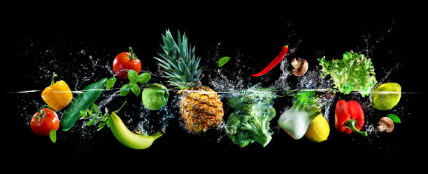 Fresh vegetables, fruits and water splashes on panoramic background
