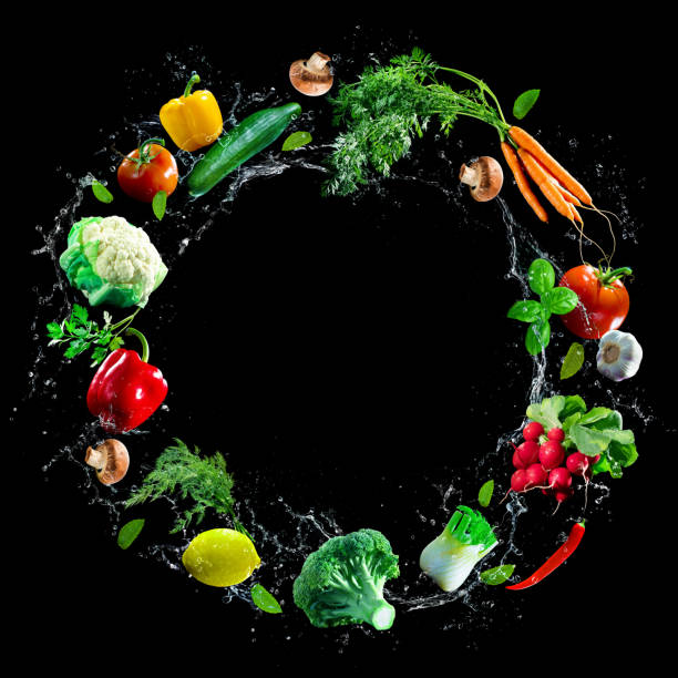 istock Assortment of fresh vegetables and water splashes on black background 1285272136