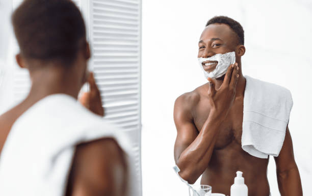 istock African Guy Applying Shave Foam Preparing For Shaving In Bathroom 1285272709