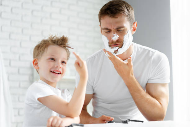 istock Father teaches his little son how to shave face 1285275546