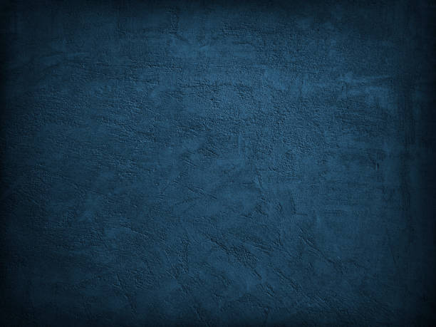 istock Deep blue grunge background. Texture of a plastered concrete wall. Dark blue grainy rough scratched surface. Toned cement background. 1285275604