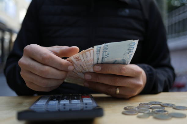 istock man doing financial transactions with calculator holding money 1285275769