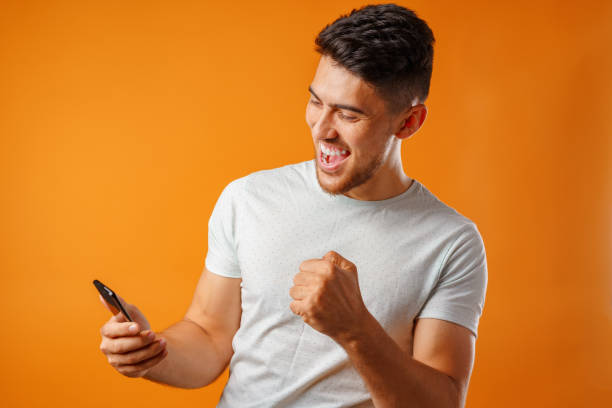 istock Young man in white shirt using his smartphone 1285277268