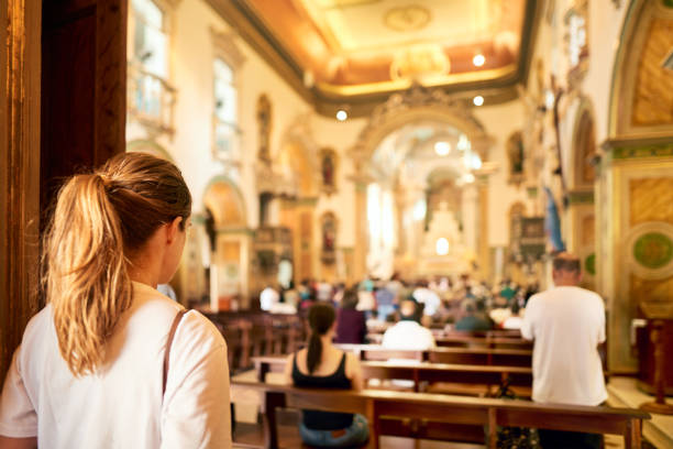 frau, die eine kirche besucht - kirche stock-fotos und bilder