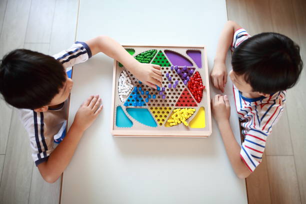 Kid playing chinese checkers Boy play Chinese checkers chinese checkers stock pictures, royalty-free photos & images