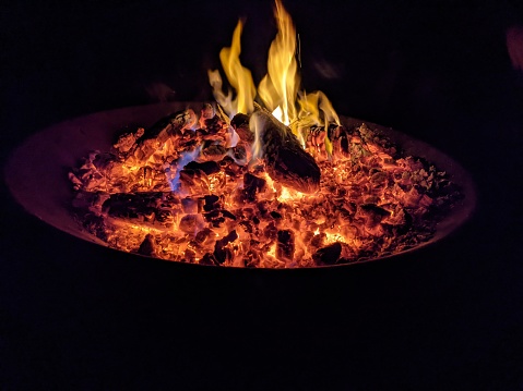 Glowing embers on a outdoor fire pit