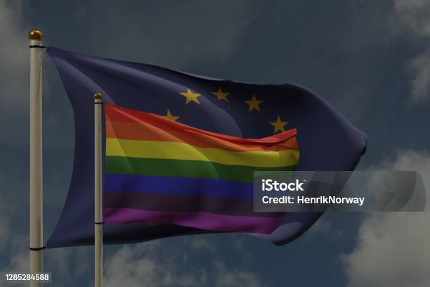 Lgbt Flag And European Union Flag On A Pole Waving In The Wind Together Representing Rights And Pride Stock Photo - Download Image Now