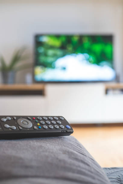 istock Remote control on the sofa, streaming on a smart TV. 1285286060
