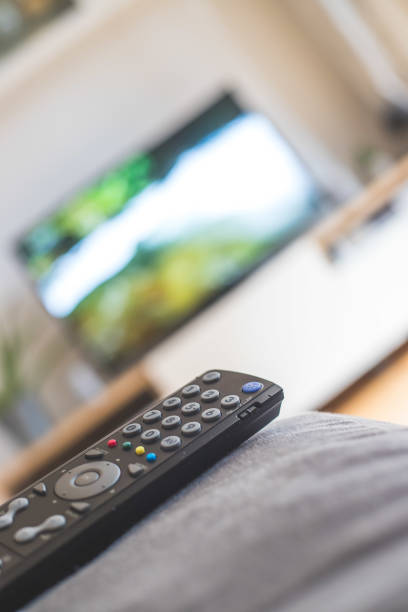 istock Remote control on the sofa, streaming on a smart TV. 1285286187