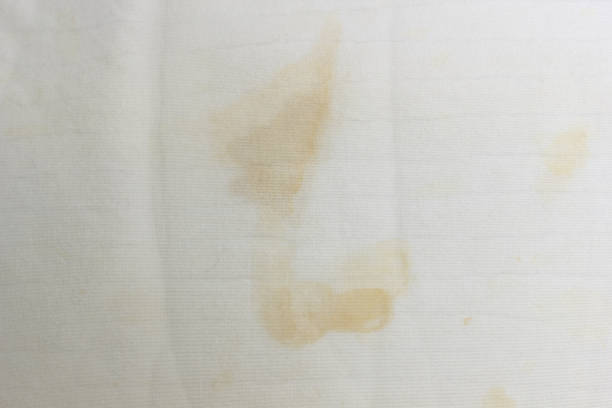 istock White old pillow with dirty stain. Selective focus 1285286474
