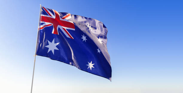 istock Flag of Australia waving against blue sky 1285288370