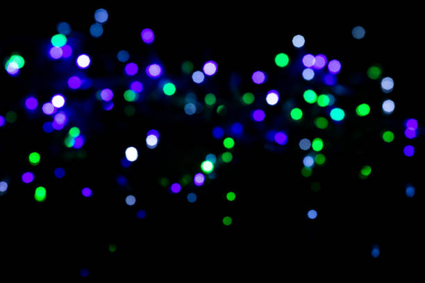 istock Multicolored spots of light against black background 1285288523