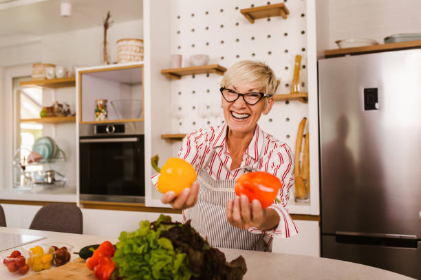 istock Happy senior woman cooking in her modern kitchen 1285288588
