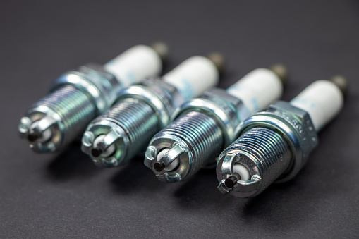 Spark plugs on black background. Car and motorcycle part.