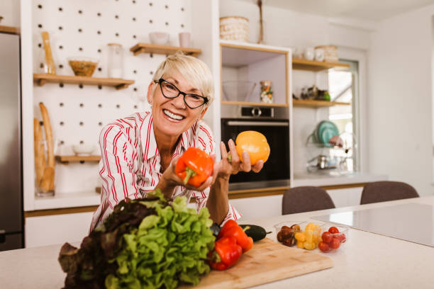 istock Happy senior woman cooking in her modern kitchen 1285289973