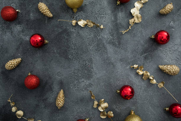 istock Christmas frame with golden and red decoration on dark background. Winter celebrations. Flat lay, top view 1285290122