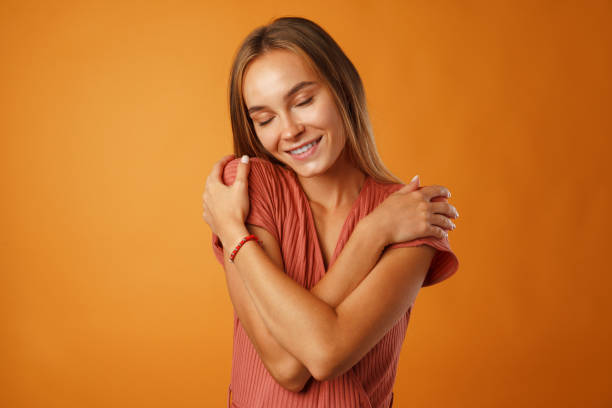istock Peaceful young blonde woman holding hands on her chest. 1285291318