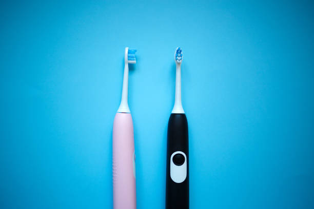 istock two ultrasonic electric toothbrushes on a blue background 1285292635