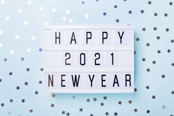 istock Lightbox with text HAPPY NEW YEAR 2021 on blue background. Top view. New year celebration. Happy New Year 2021 concepts 1285293024