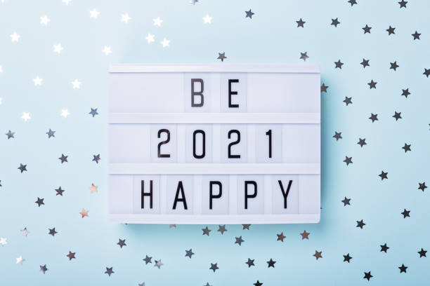 istock Lightbox with text BE HAPPY 2021 on blue background. Top view. New year celebration. Happy New Year 2021 concepts 1285293042