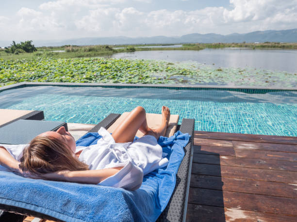istock Woman relaxing by the poolside 1285293535