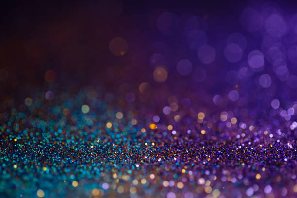 istock Decoration bokeh lights background, abstract sparkle backdrop with circles,modern design overlay with sparkling glimmers. Blue, purple and golden backdrop glittering sparks with blur effect. 1285294750