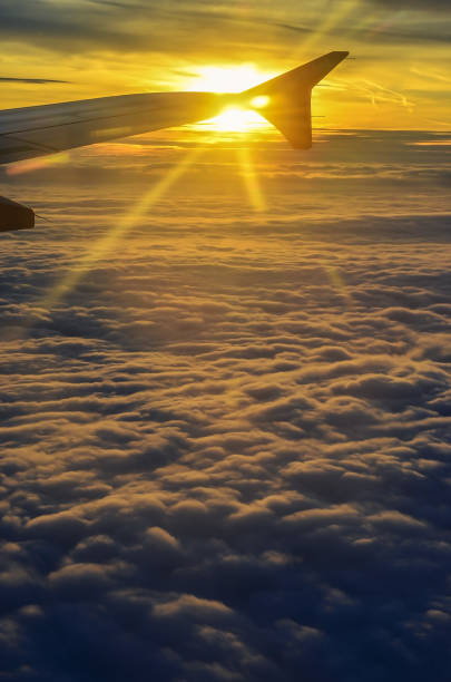 istock Beautifull golden sunrise view from airplane window 1285295245