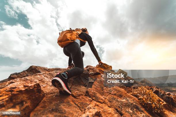 Success Woman Hiker Hiking On Sunrise Mountain Peak Young Woman With Backpack Rise To The Mountain Top Discovery Travel Destination Concept Stock Photo - Download Image Now