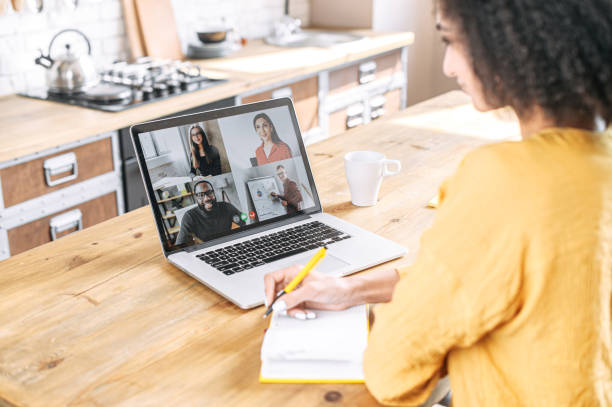An african woman using laptop for video meeting
