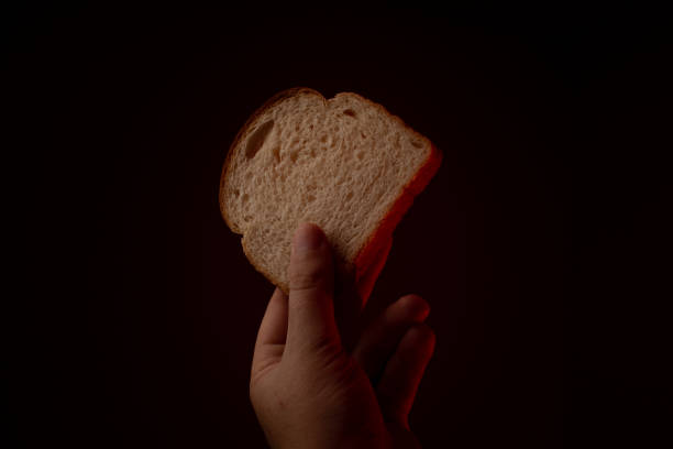 istock Hand that gives a slice of bread 1285302914
