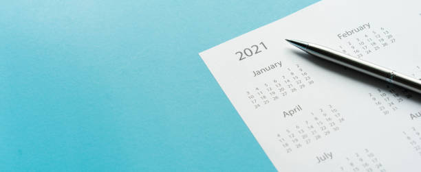 istock close up top view on white calendar 2021 schedule on blue color background to make appointment meeting or manage timetable each day for design planning work and life concept 1285304569