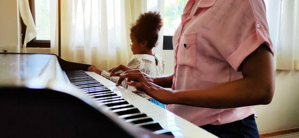 istock Mother is teaching and learning to play the piano at home. 1285304890