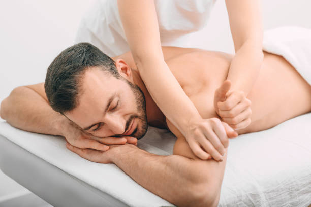 istock Handsome arab man enjoying back massage at spa salon. Relaxing massage at the spa 1285305550