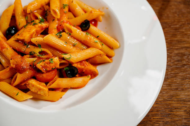 istock Spaghetti pasta with tomatoes and parsley on wooden table 1285306884