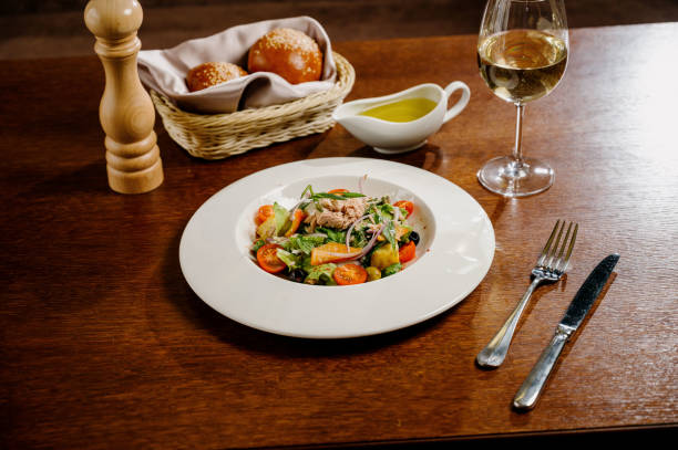 istock Caesar salad with croutons, quail eggs, cherry tomatoes and grilled chicken in wooden table 1285306894