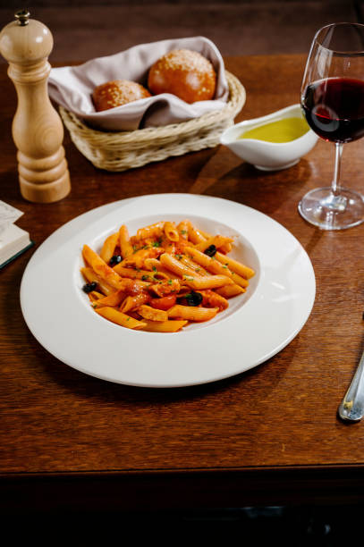 istock Spaghetti pasta with tomatoes and parsley on wooden table 1285307141