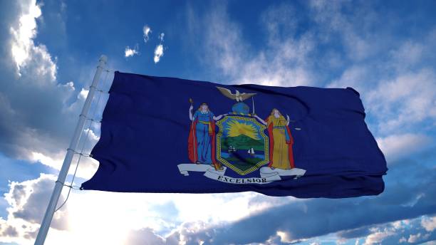 istock New York flag on a flagpole waving in the wind, blue sky background. 3d rendering 1285308153