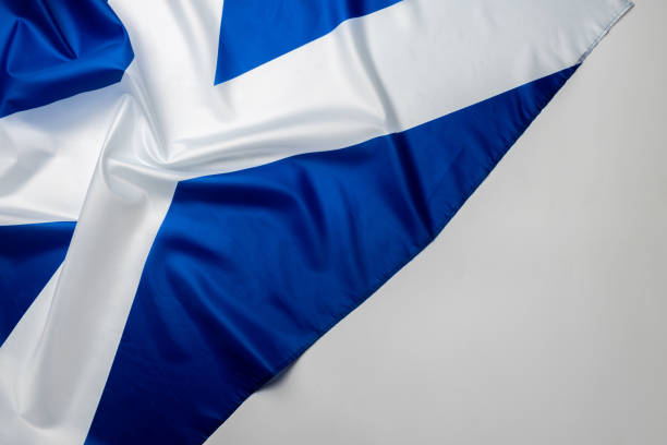 istock Rippled flag of Scotland lying on white surface 1285308215