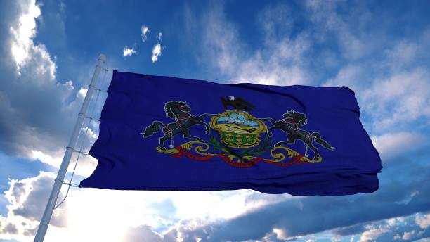 istock Pennsylvania flag on a flagpole waving in the wind, blue sky background. 3d rendering 1285308253
