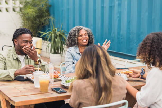 istock Diverse friends enjoy hearty laugh during lunch 1285308709