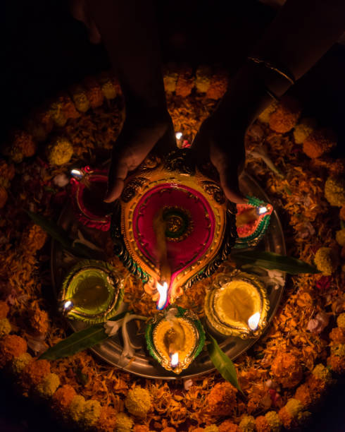 istock Female hands holding a diya or lamp 1285308726