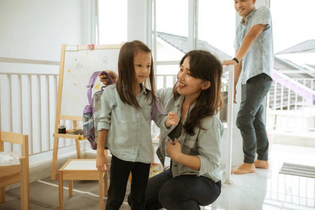 istock Father, Mother getting daughter (5 yrs) ready for school 1285308960
