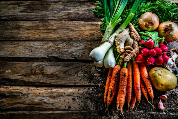 istock Healthy fresh organic root vegetables on rustic wooden table. Copy space 1285309647