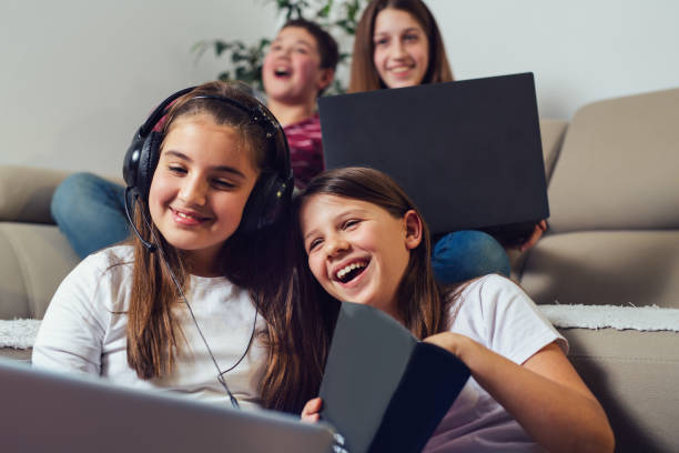 istock Laughing friends watching funny video on laptop 1285309966