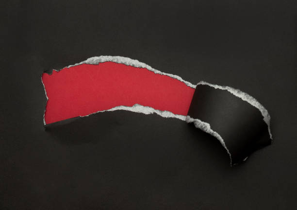 istock Black torn paper on red background. Black Friday campaign 1285310017