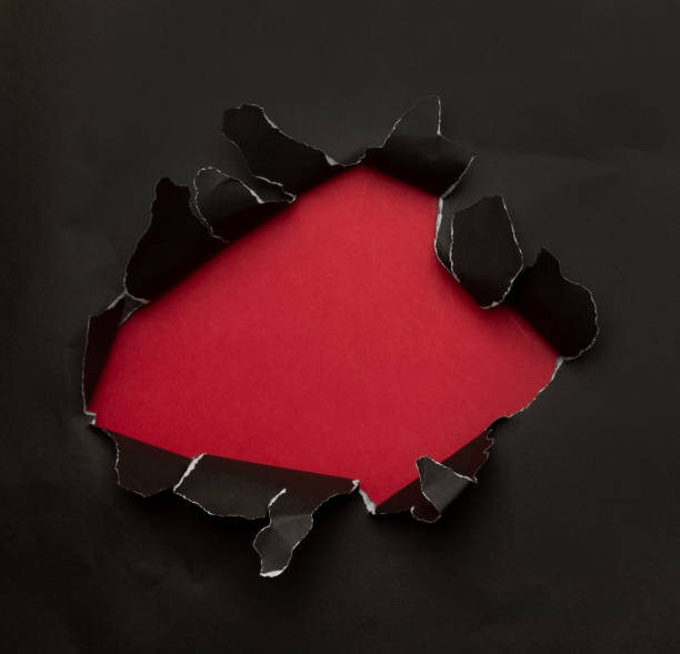 istock Black torn paper on red background. Black Friday campaign 1285310034