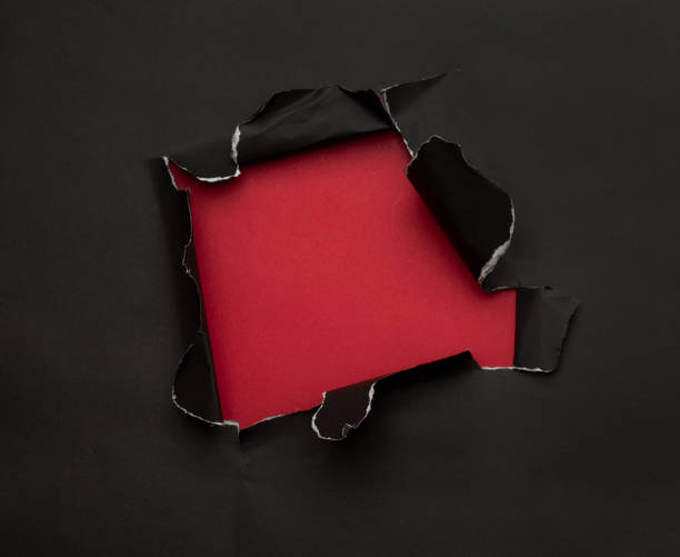 istock Black torn paper on red background. Black Friday campaign 1285310038