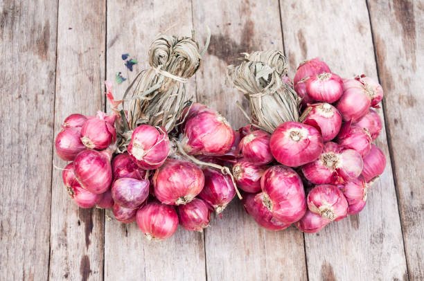 istock Red onions group on grunge texture wooden background 1285310043