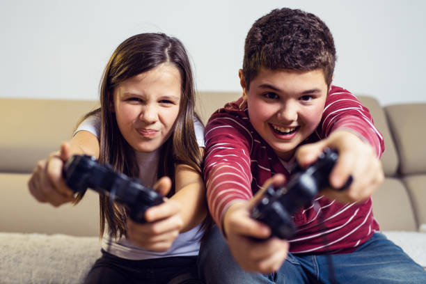 istock Happy children playing computer games at home 1285310651